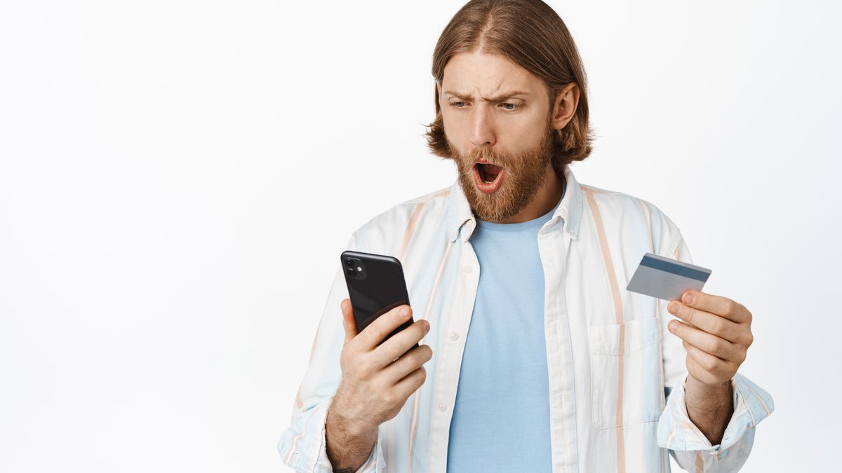 Shocked smartphone user looking at unexpected high in-app subscription renewal charges